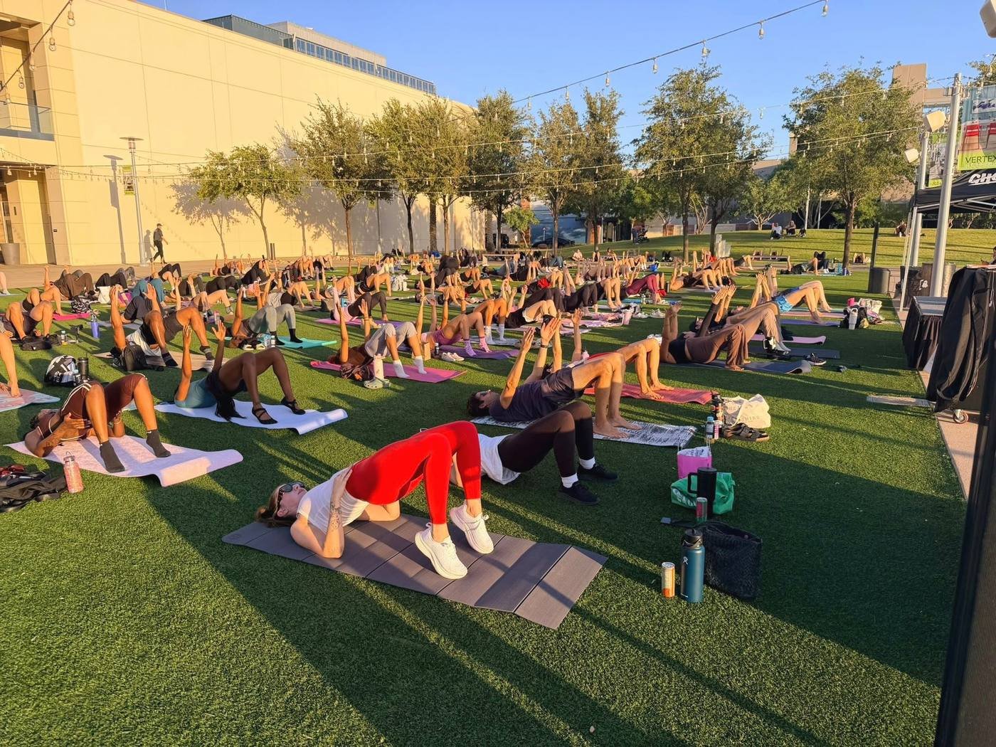 A sold-out Paula’s Method class filling the lawn at golden hour